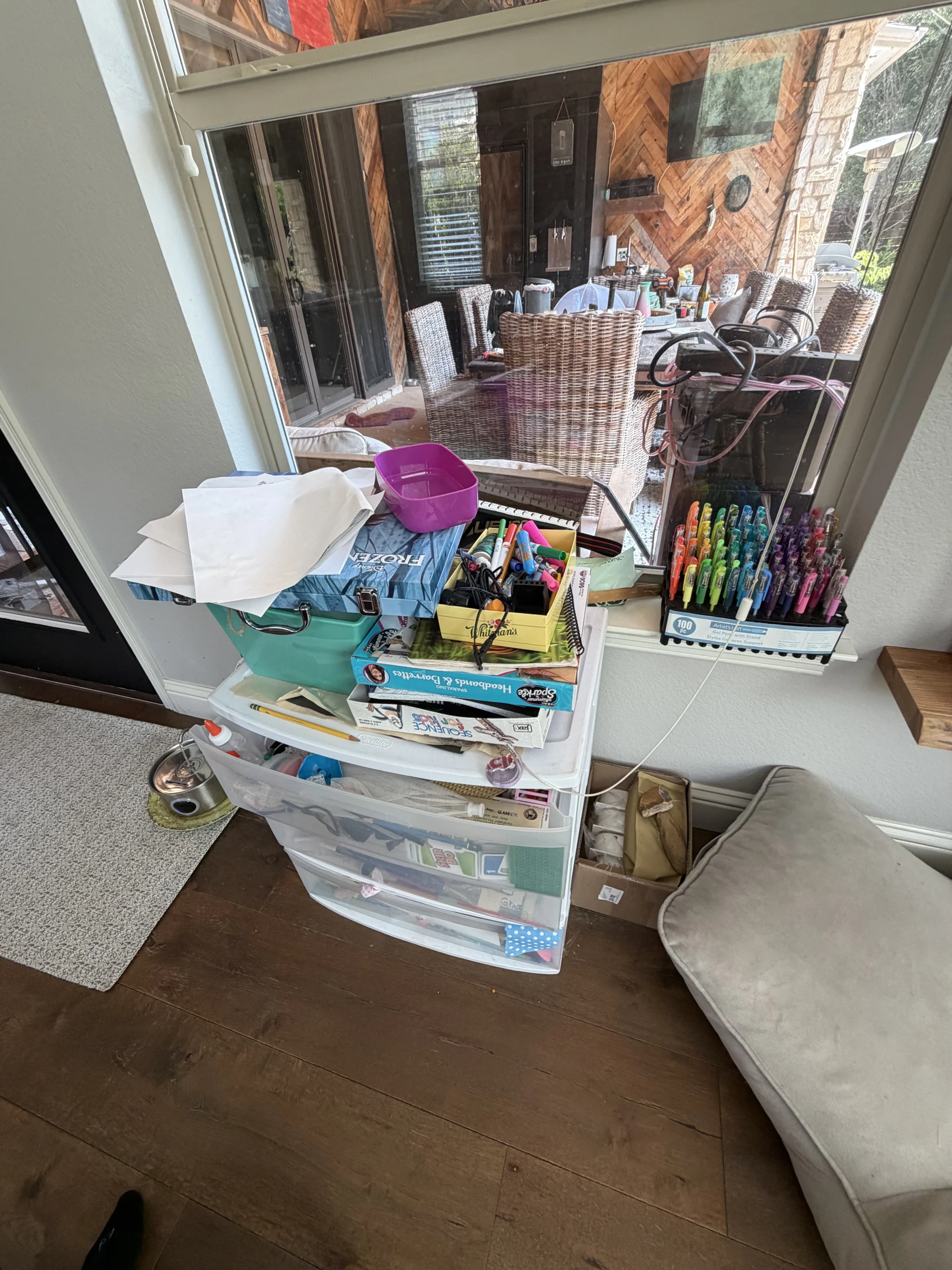 Cluttered kids' play space before Top Tier Tidying organized it