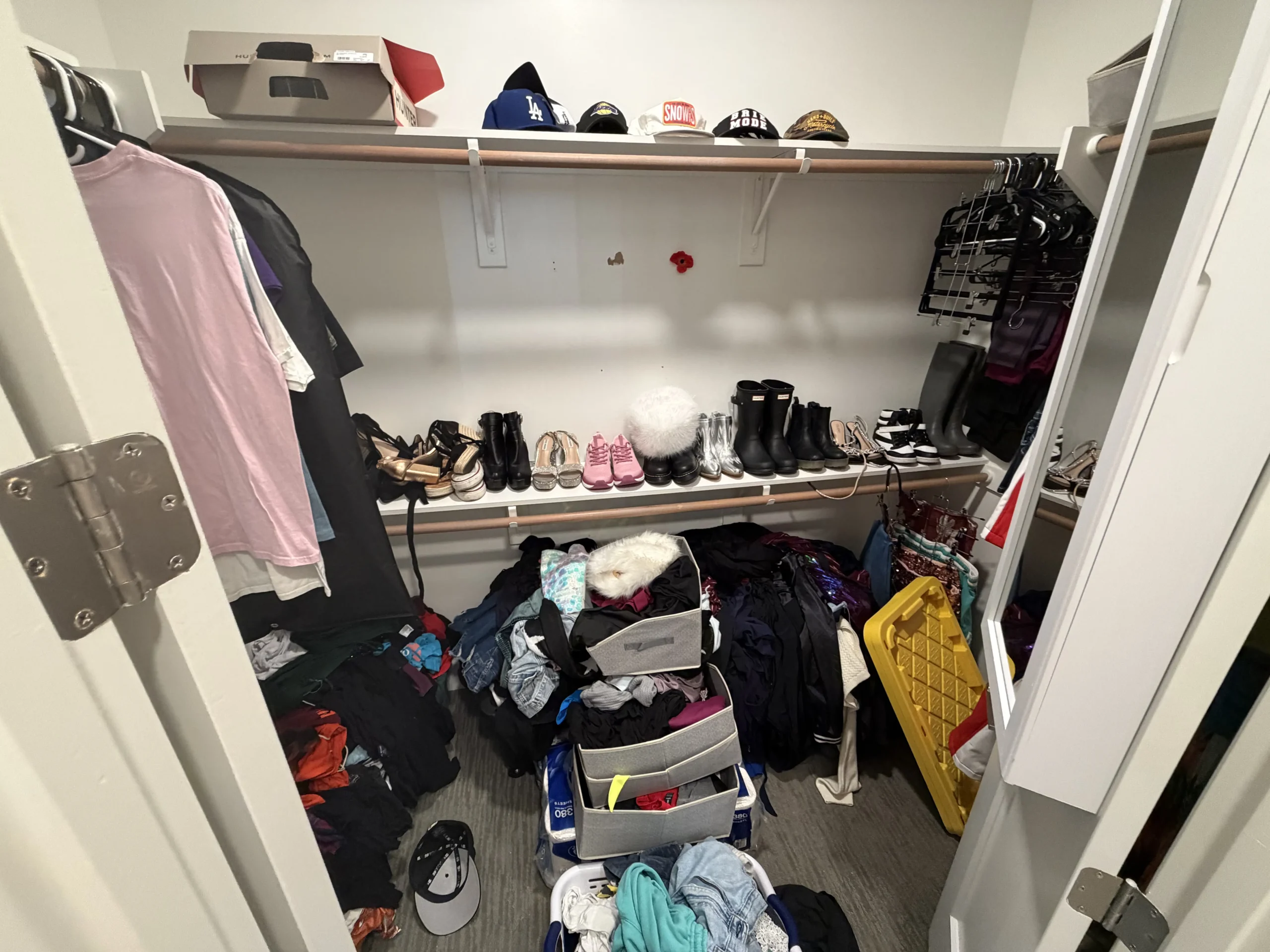 Cluttered closet before Top Tier Tidying organized it