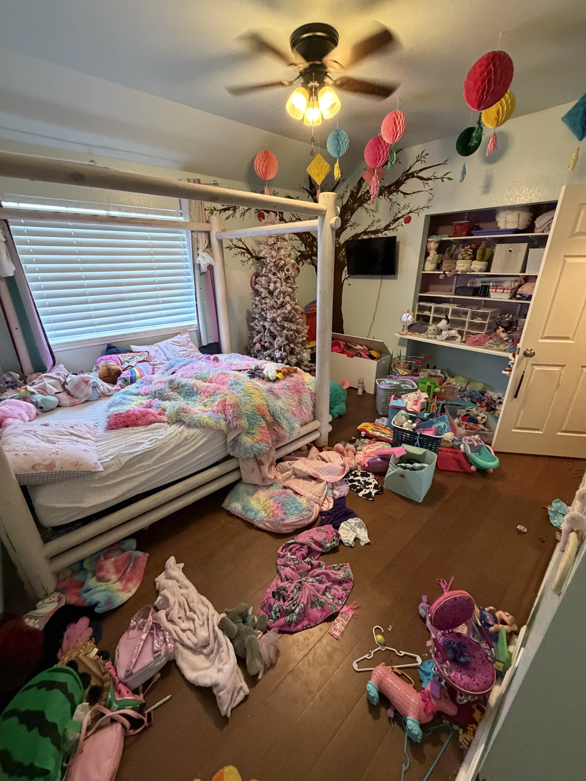 Cluttered kids' play space before Top Tier Tidying organized it