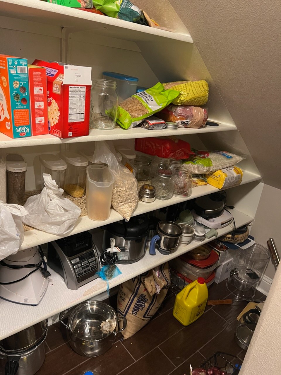 Cluttered pantry or kitchen before Top Tier Tidying organized it