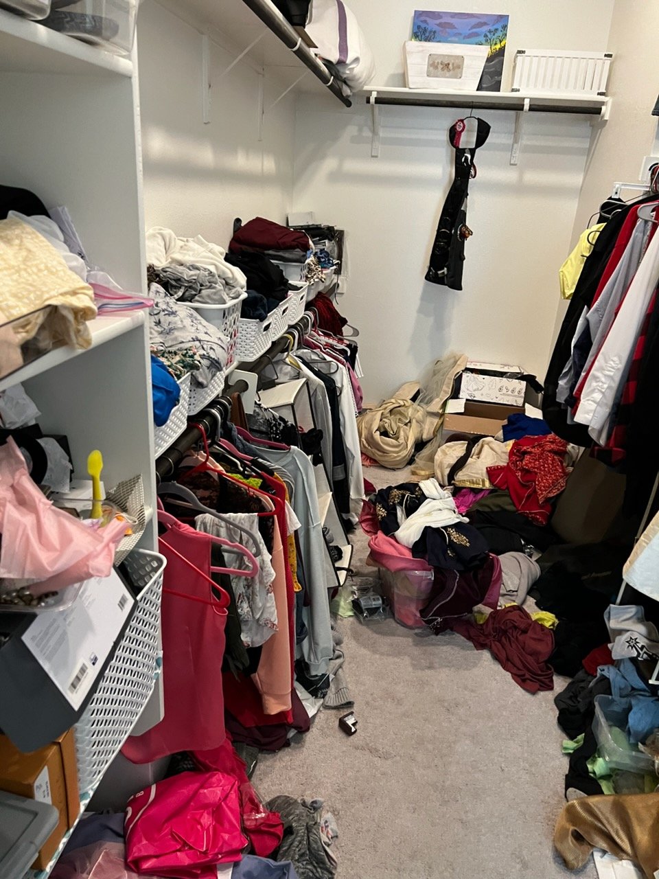 Cluttered closet before Top Tier Tidying organized it