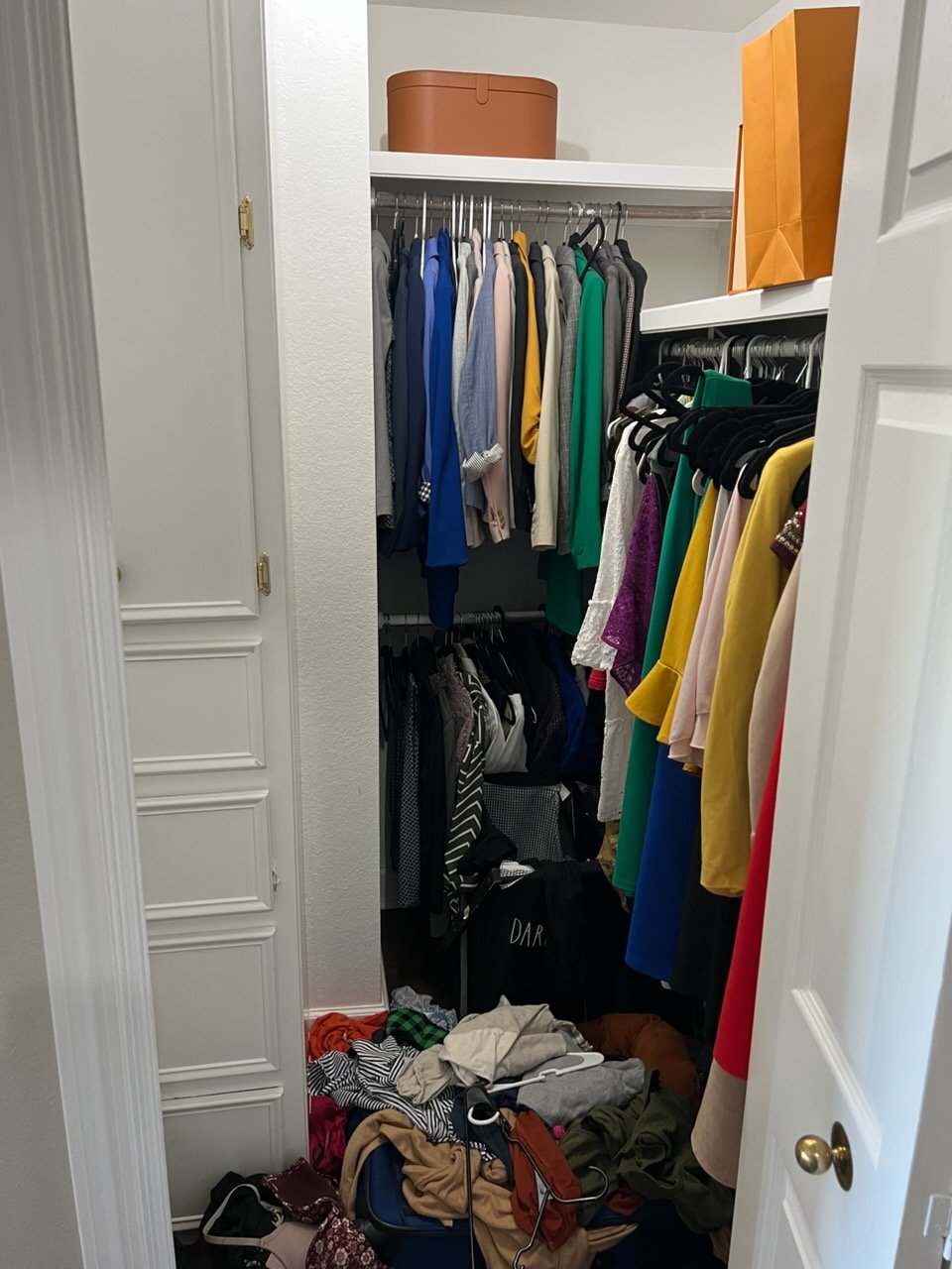 Cluttered closet before Top Tier Tidying organized it