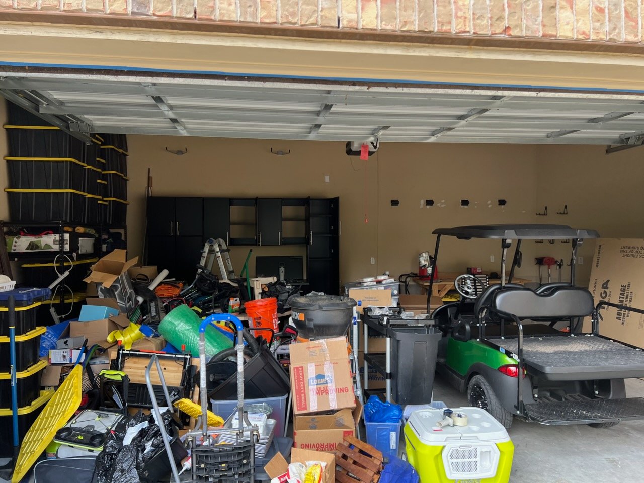 Cluttered garage before Top Tier Tidying organized it