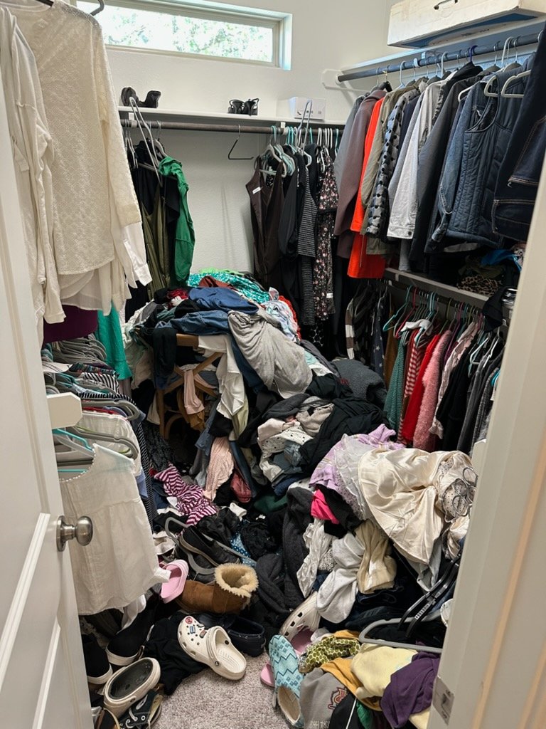 Cluttered closet before Top Tier Tidying organized it