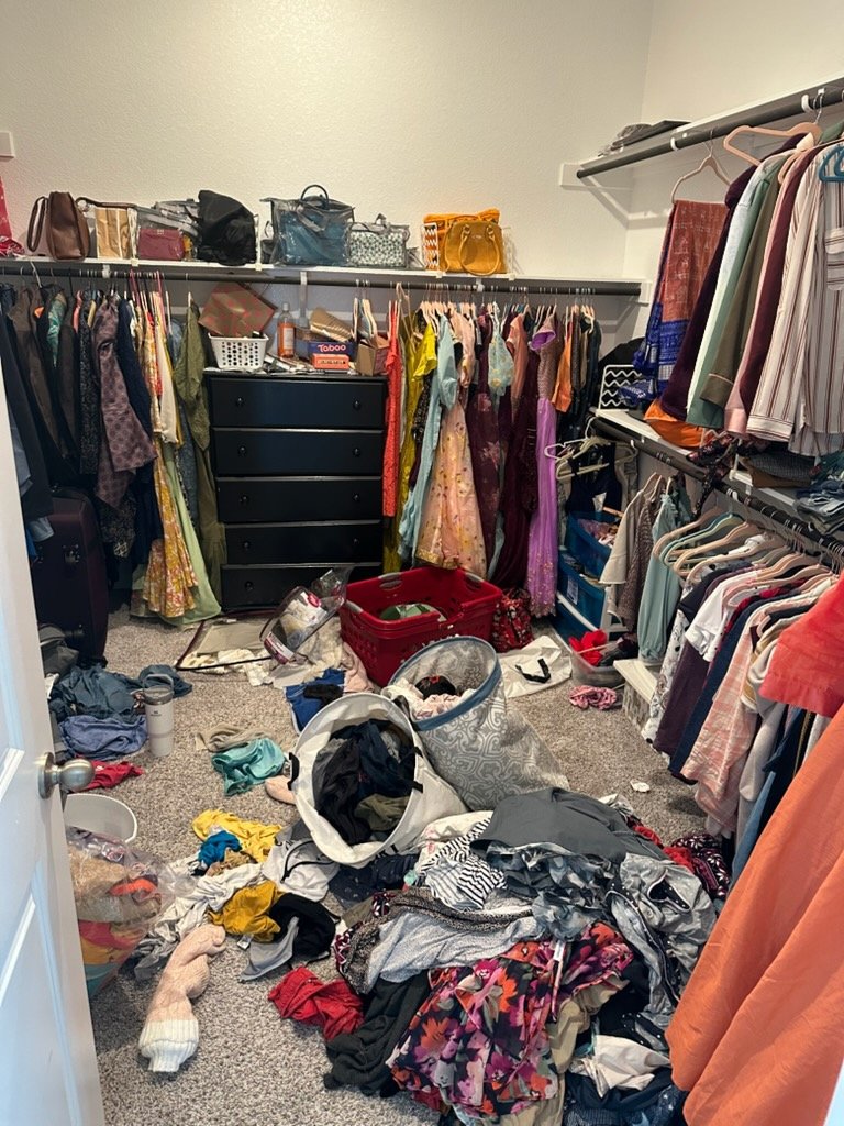 Cluttered closet before Top Tier Tidying organized it