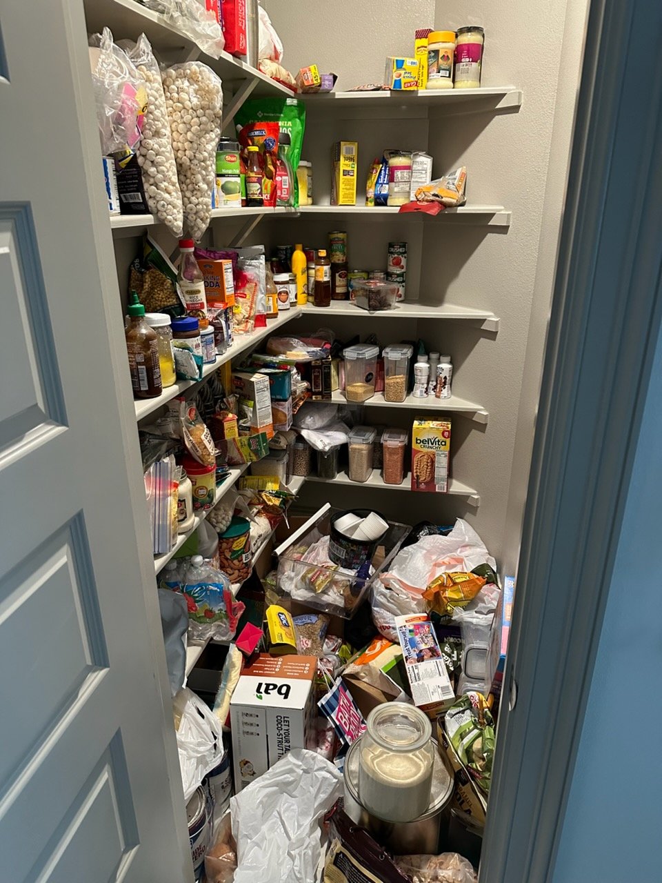 Cluttered pantry or kitchen before Top Tier Tidying organized it