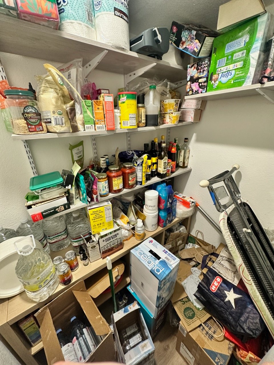 Cluttered pantry or kitchen before Top Tier Tidying organized it